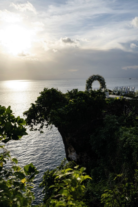 Cliff edge sunset with wedding arch silhouette